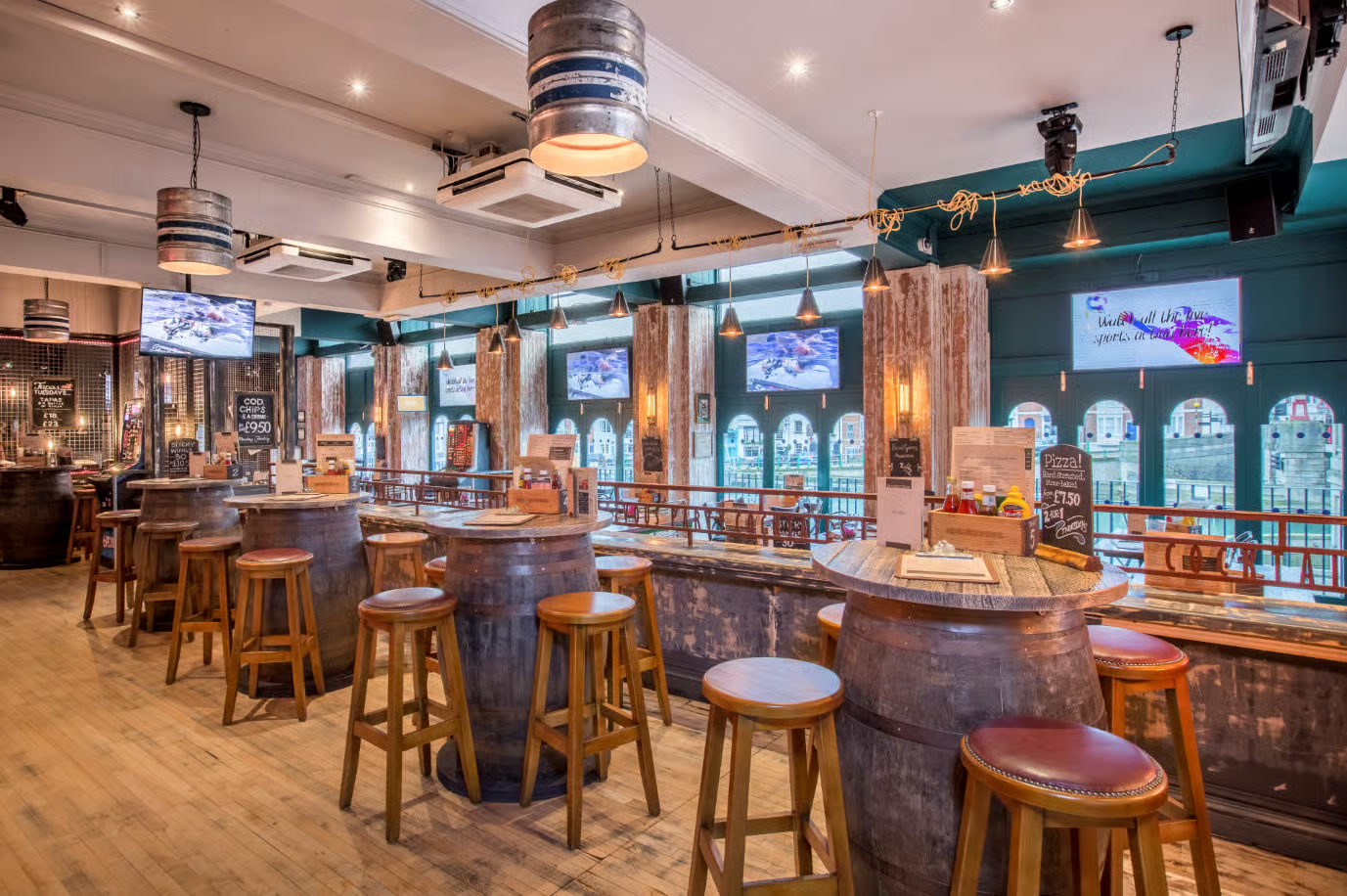 Rendezvous main floor bar and restaurant — bright, family-friendly dining space with booths and pendant lighting
